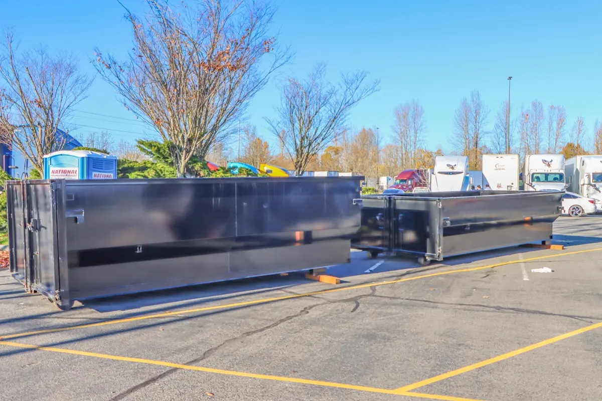 Professional dumpster rental service with roll-off container on residential driveway in Walkertown